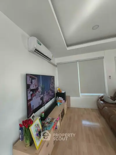 Modern living room with sleek TV setup and cozy seating area