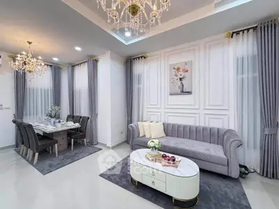 Luxurious living and dining area with elegant chandeliers and modern decor