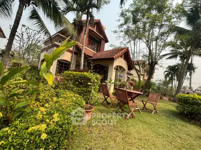 Charming villa with lush garden and outdoor seating, showcasing elegant architecture and tranquil surroundings for a serene living experience.