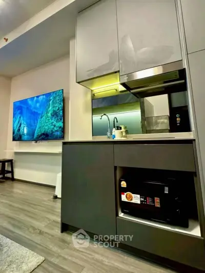 Modern kitchen with sleek cabinetry and built-in appliances in a stylish apartment.