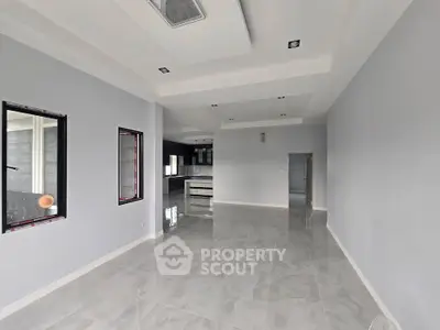 Spacious open-plan living area with modern finishes and large windows.