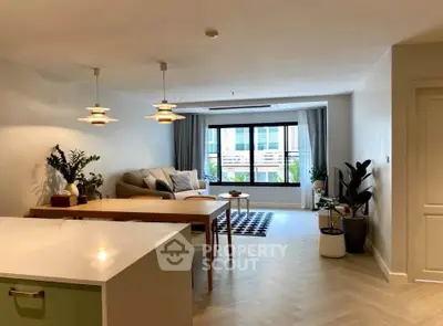 Spacious modern living room with stylish decor and large windows in a contemporary apartment.