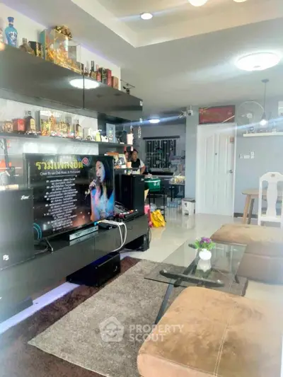 Spacious living room with modern decor and entertainment setup, perfect for relaxation and gatherings.