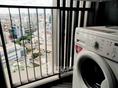 High-rise apartment balcony with stunning city view and washing machine.