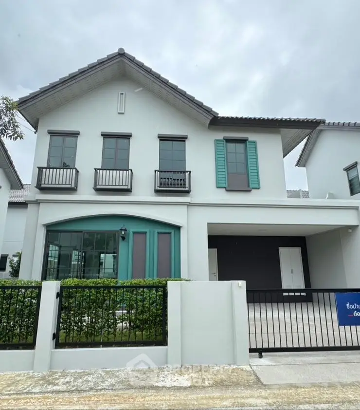 Modern two-story house with stylish facade and gated driveway