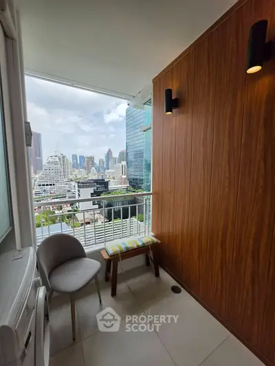 Stylish balcony with city view, modern seating, and wooden paneling in urban apartment.