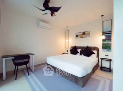 Modern bedroom with stylish decor, featuring a comfortable bed, sleek desk, and elegant lighting.