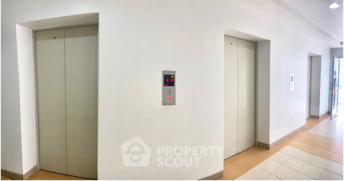 Modern building elevator lobby with two elevators and digital floor display