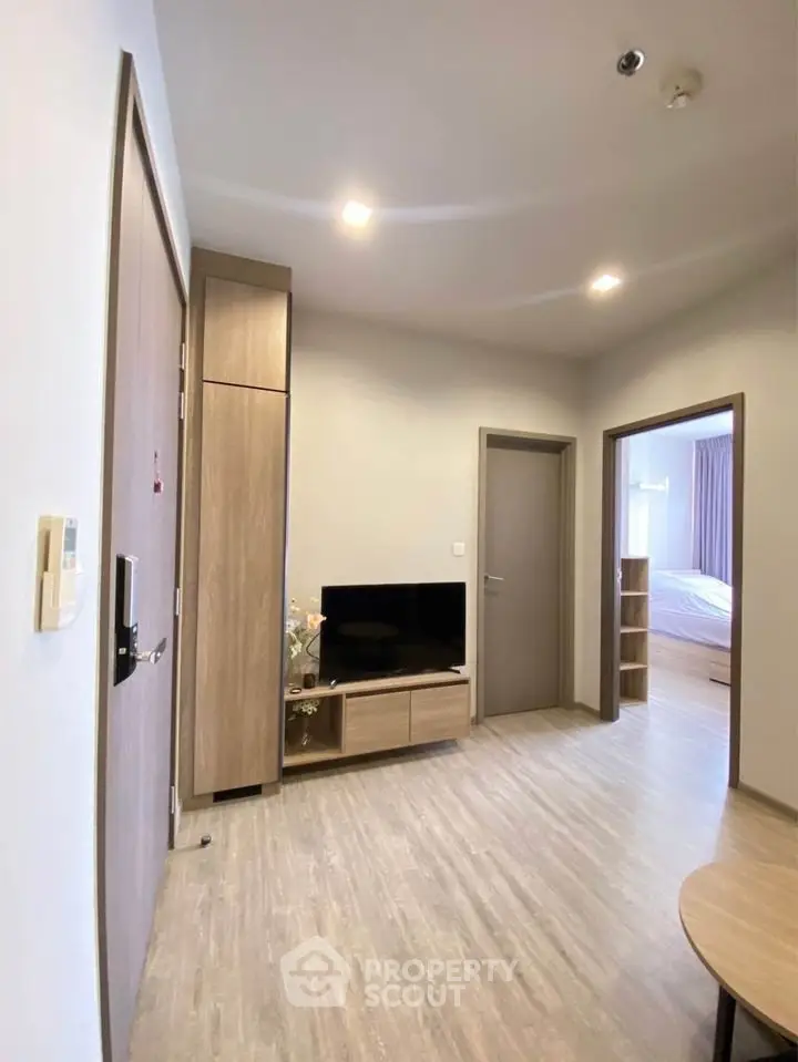 Modern apartment interior with sleek wooden flooring and stylish furniture, showcasing a cozy living space.