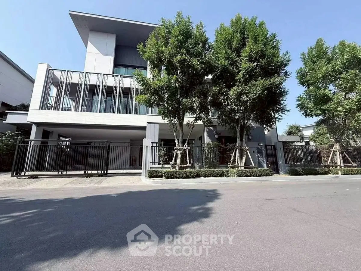 Modern multi-story building with sleek design and lush greenery