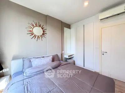 Modern bedroom with stylish decor and air conditioning in a cozy apartment.