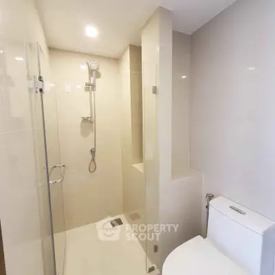 Modern bathroom with glass shower enclosure and sleek fixtures