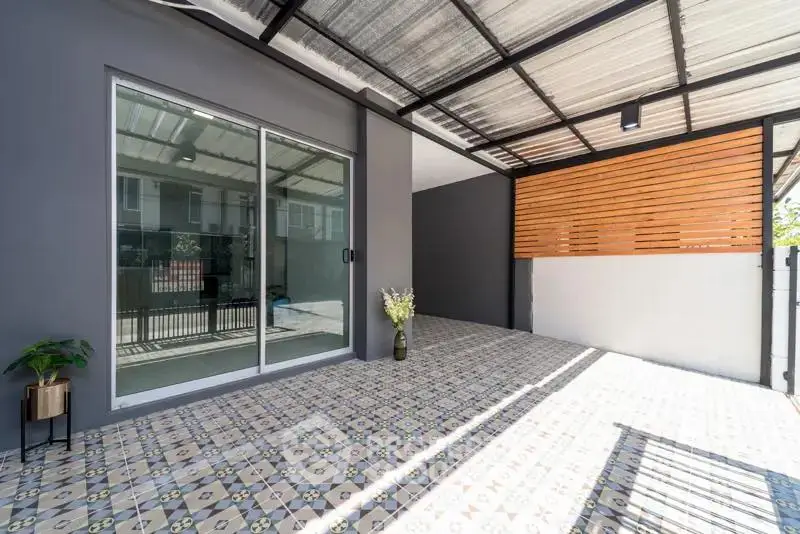 Modern covered patio with stylish tiles and sliding glass door