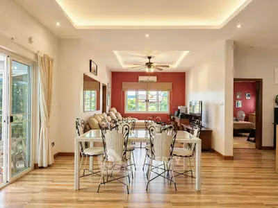 Spacious open-plan living and dining area with elegant decor and natural light.
