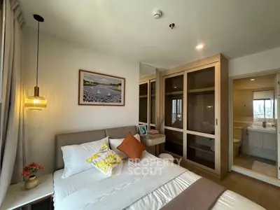 Modern bedroom with ensuite bathroom, stylish decor, and ample natural light.