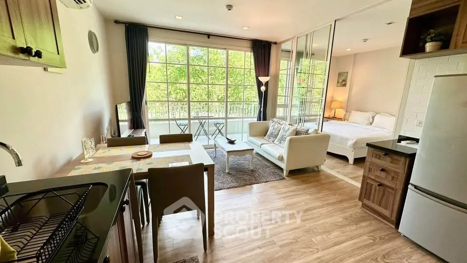 Modern open-plan living room with dining area and bedroom, featuring large windows and stylish decor.