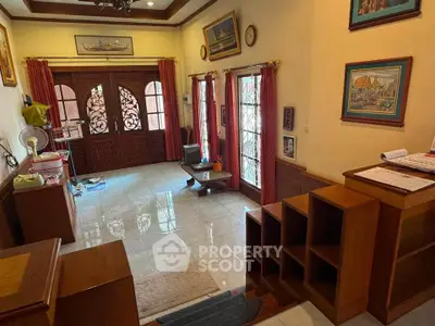 Charming living room with elegant wooden decor and natural light, perfect for cozy gatherings.