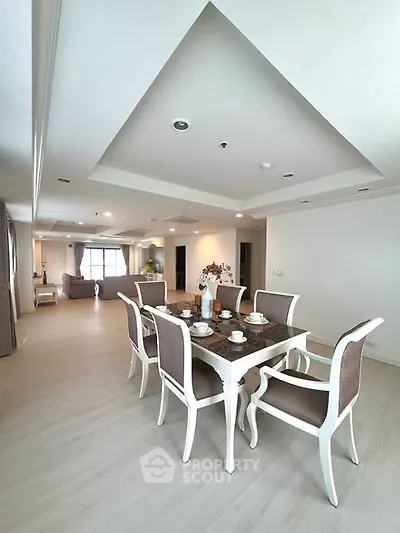 Spacious open-plan living and dining area with elegant furniture and modern decor.