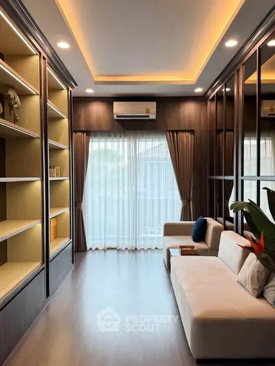 Elegant living room with modern shelving, cozy sofa, and large window with curtains, perfect for relaxation.