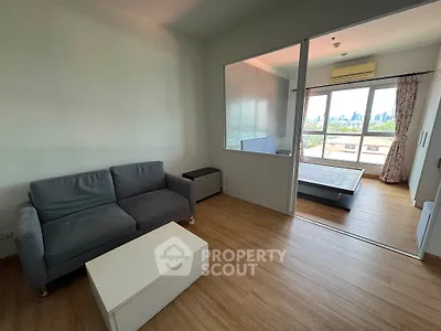 Modern apartment with spacious living room and bedroom featuring city skyline view.