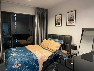 Cozy bedroom with modern decor, featuring a stylish bed, elegant curtains, and chic wall art.