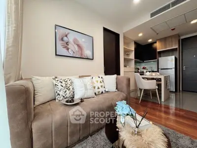 Stylish modern living room with cozy sofa and open kitchen layout in a contemporary apartment.