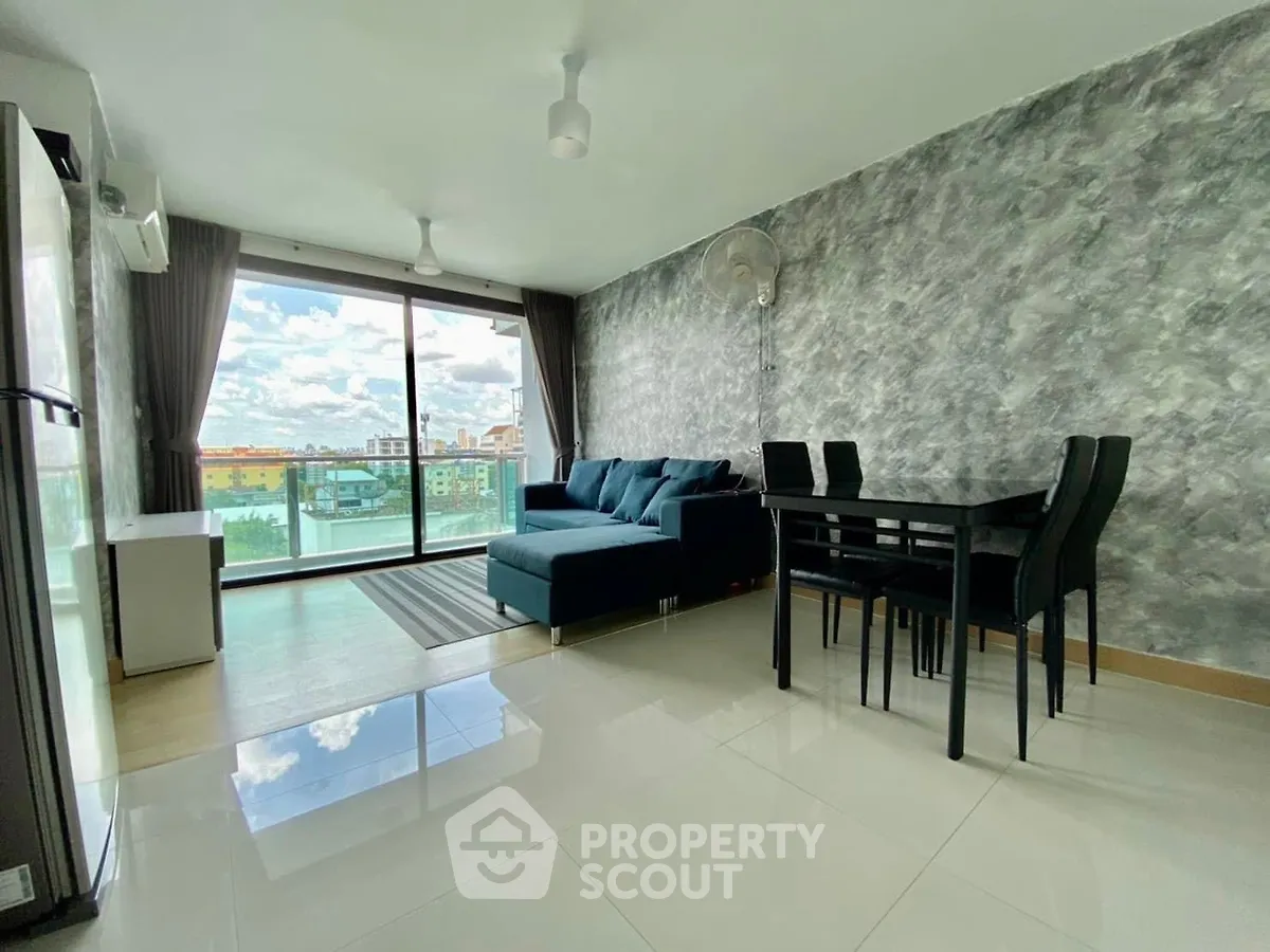 Modern living room with stylish decor and stunning city view from large windows.