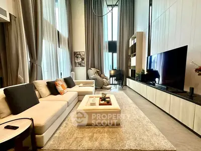 Luxurious modern living room with high ceilings, elegant decor, and large windows for natural light.