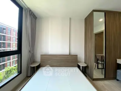 Modern bedroom with large window and stylish wooden furniture