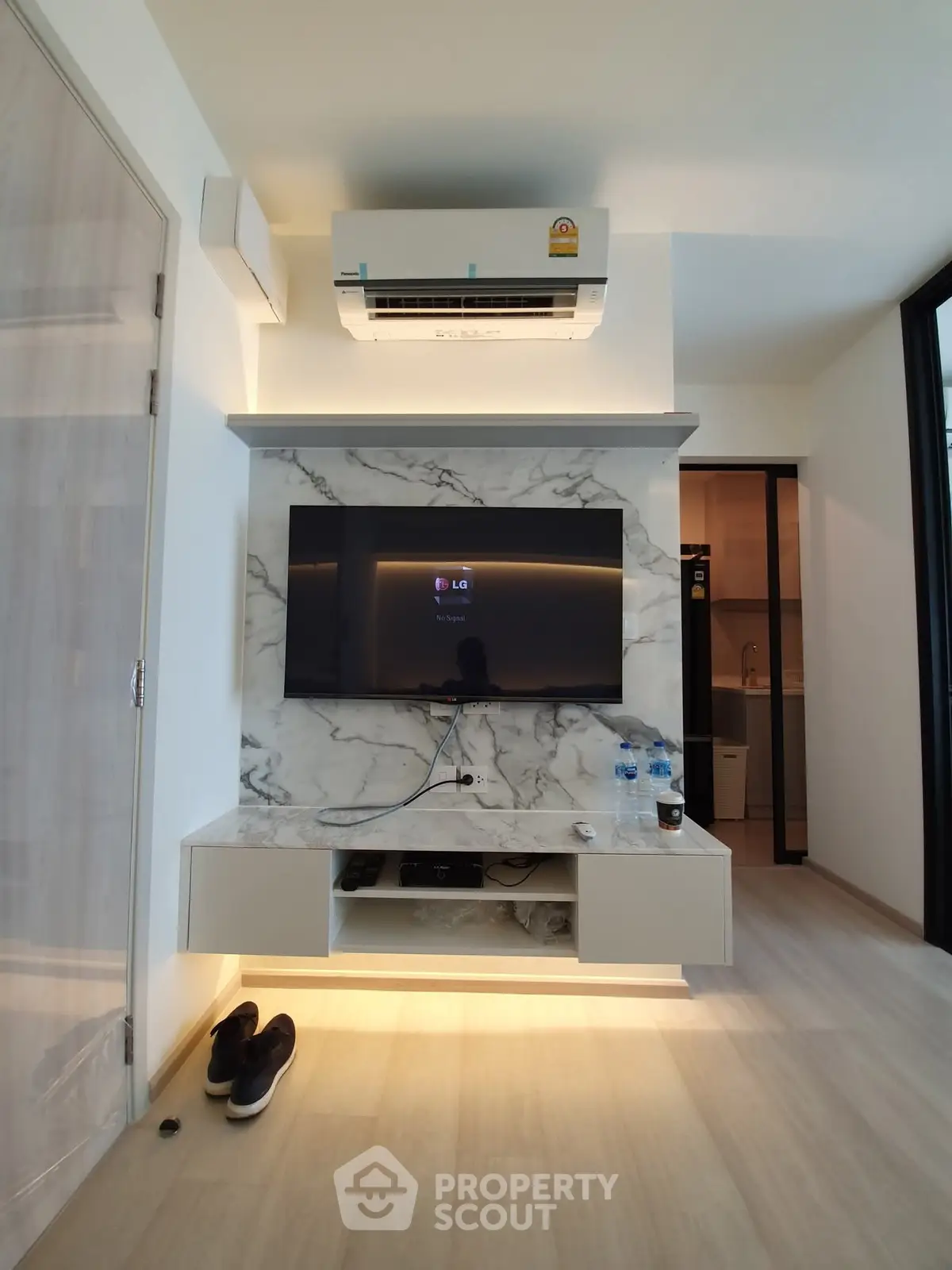 Modern living room with marble TV wall and air conditioning unit