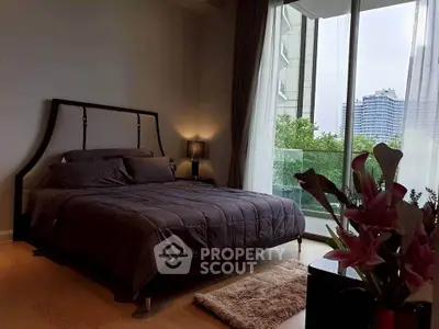 Luxurious bedroom with modern decor and city view balcony, perfect for urban living.