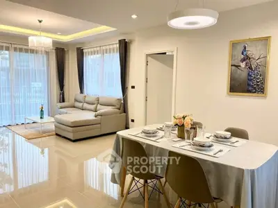 Elegant open-plan living and dining area with modern decor and natural light.
