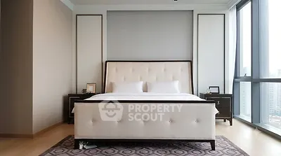 Luxurious bedroom with modern decor and large windows offering city views