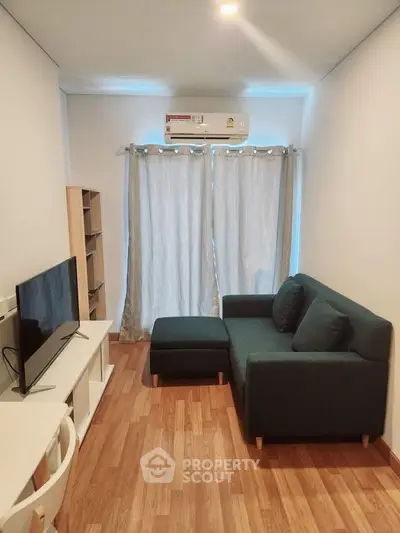 Cozy living room with modern furniture and natural light, perfect for relaxation and entertainment.