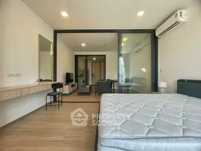 Spacious modern bedroom with open layout and stylish furnishings in a contemporary apartment.