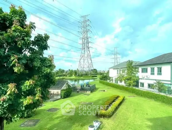 Spacious garden view with lush greenery and modern residential buildings.