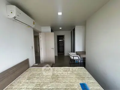 Modern bedroom with minimalist design and air conditioning in a stylish apartment.