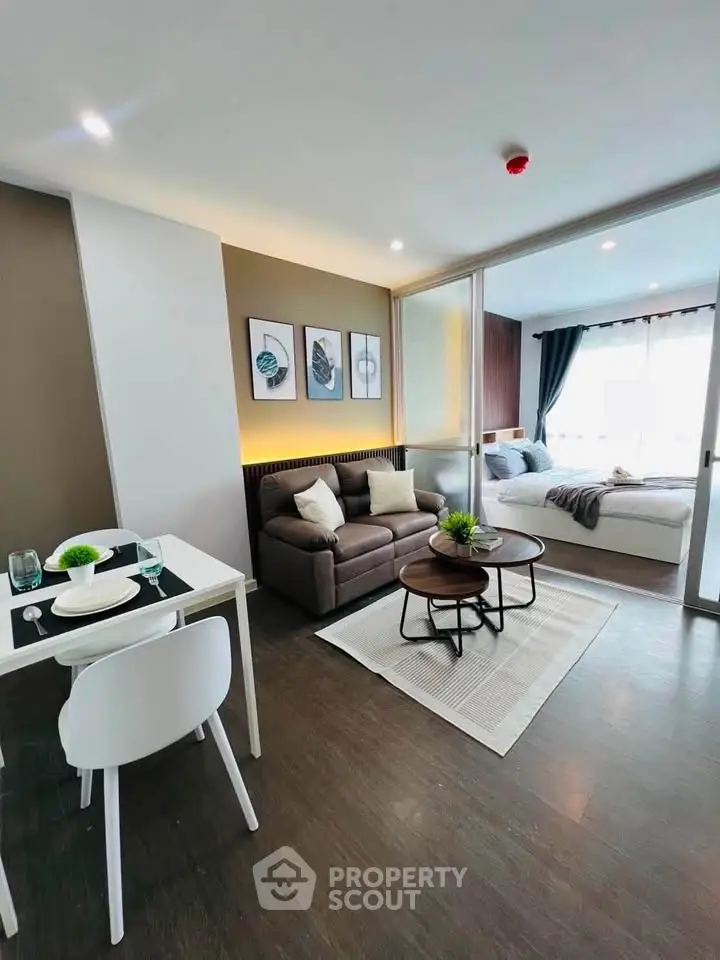 Modern open-plan living room with cozy seating and stylish decor in a bright apartment.