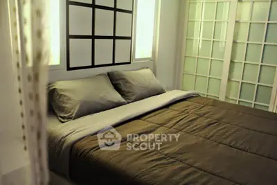 Cozy bedroom with modern decor and soft lighting, featuring a comfortable bed and stylish sliding doors.