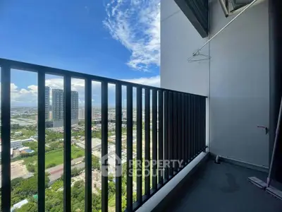 Stunning high-rise balcony with panoramic city views and modern railing design.