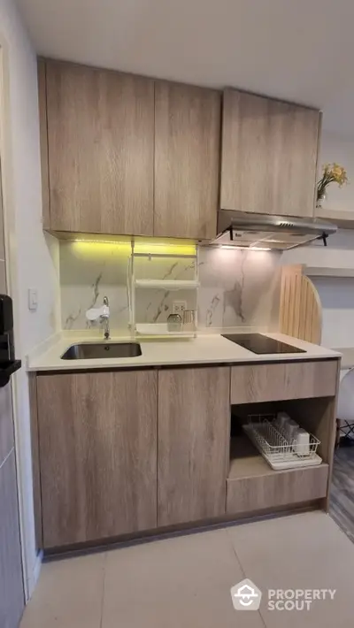 Modern kitchen with sleek wooden cabinets and integrated appliances