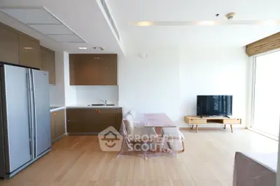 Modern open-layout kitchen and living area with sleek appliances and natural light.