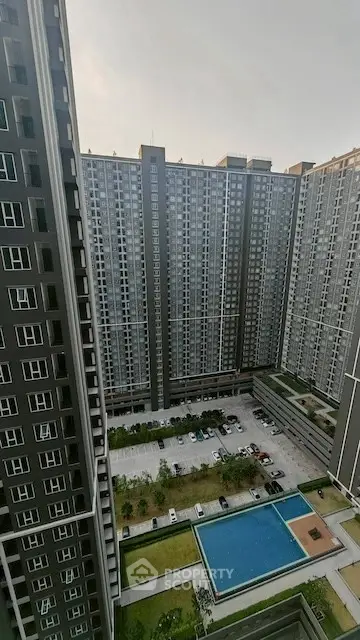 Stunning high-rise apartment complex with pool and parking view