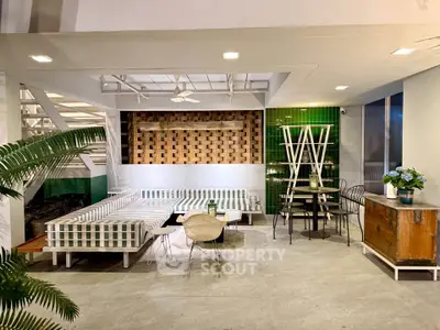 Stylish modern living area with chic furniture and green accents, perfect for relaxation and entertaining.