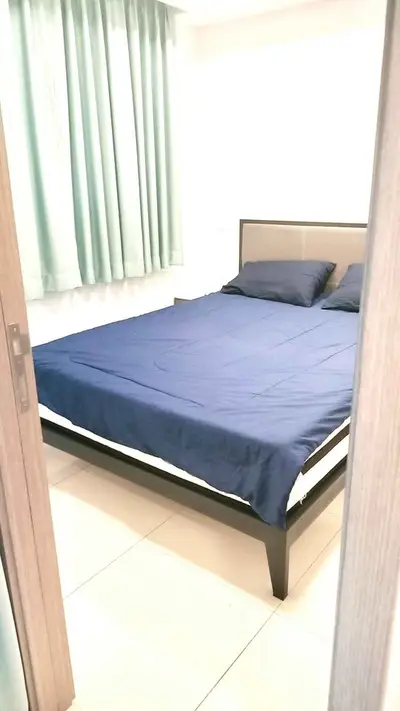 Cozy bedroom with modern bed and stylish curtains, perfect for restful nights.