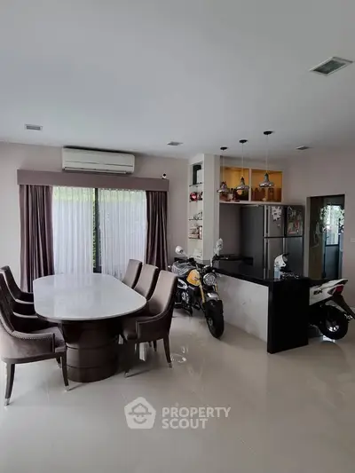 Spacious dining area with modern kitchen and unique scooter decor
