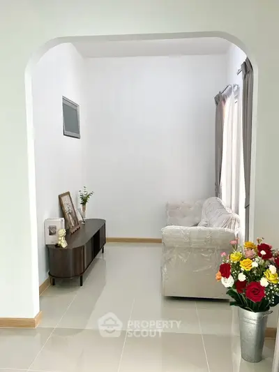 Elegant living room with plush sofa and decorative accents in a bright, airy space.