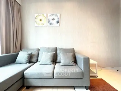 Modern living room with stylish gray sofa and elegant wall art, perfect for contemporary urban living.