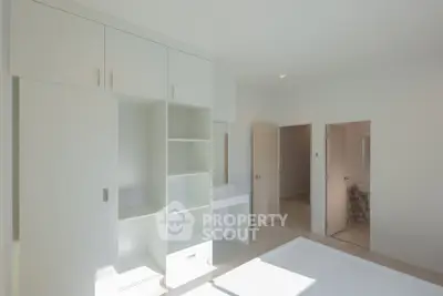 Bright minimalist bedroom with built-in storage and ensuite bathroom