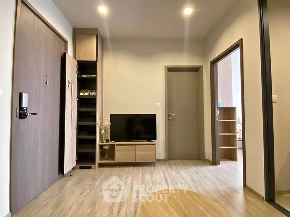 Modern living room with wooden flooring and sleek furniture in a contemporary apartment.